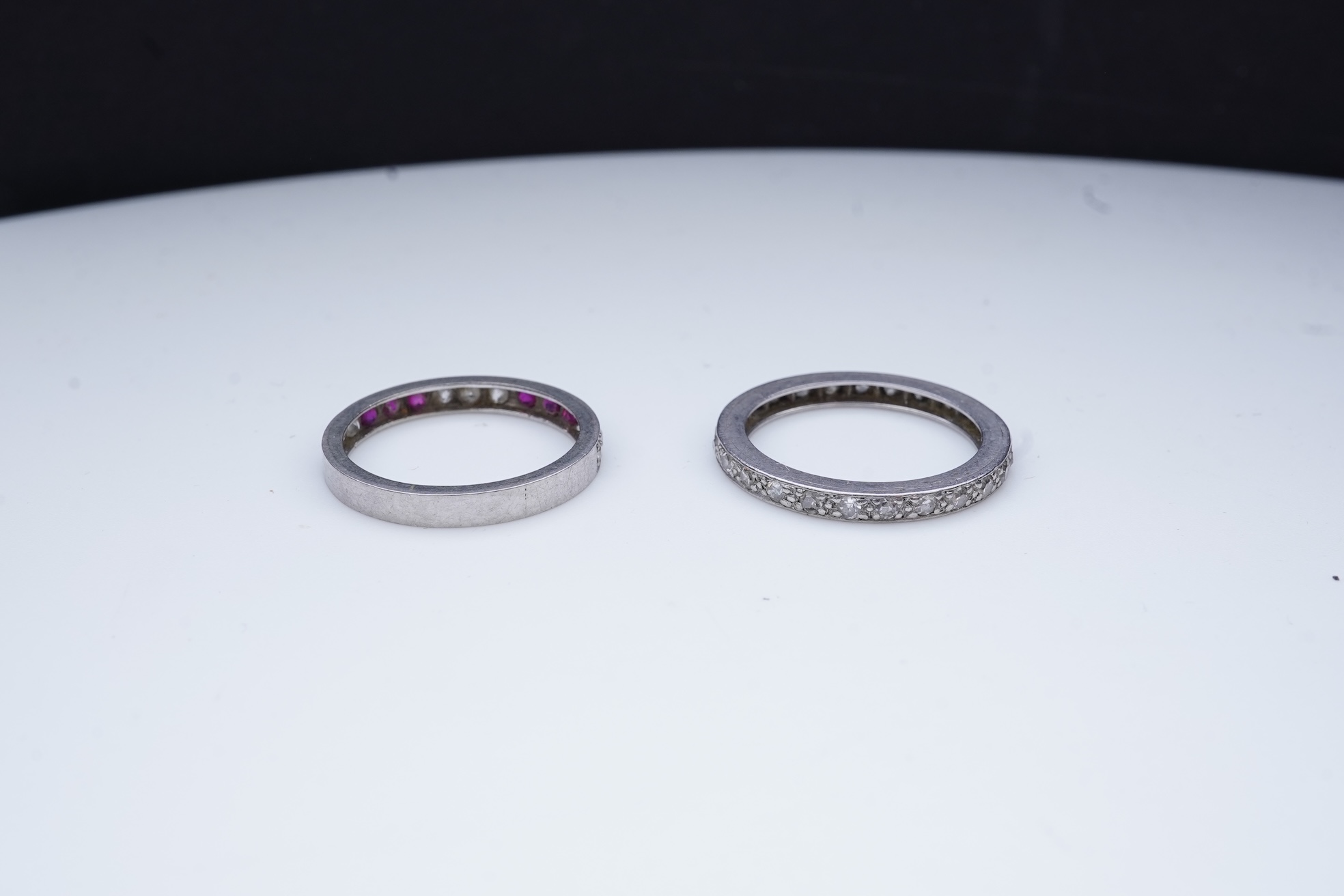 A diamond eternity ring and a ruby and diamond half eternity ring, mid 20th century